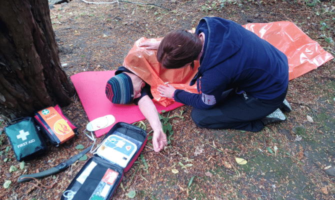 A first aid training scenario in the woods